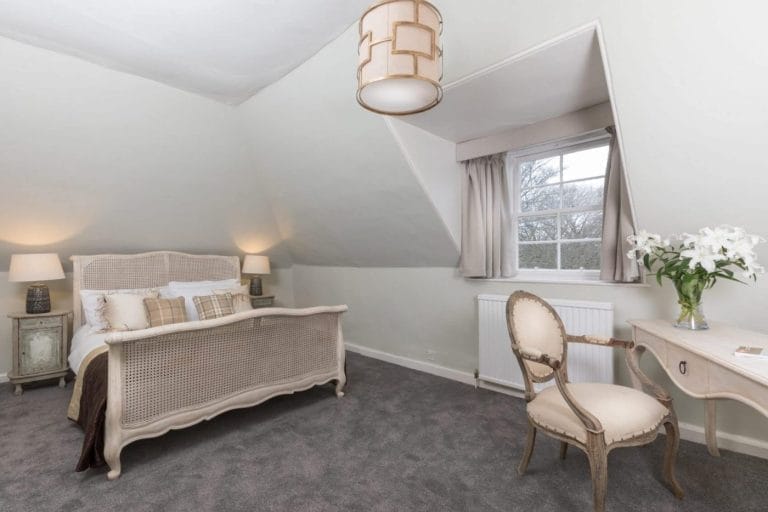 8 Tip Penjagaan Rumah yang Akan Menjimatkan Anda Beribu-Ribu Ringgit - Nombor 5 Akan Mengejutkan Anda! 😱💸 6 Elegant bedroom with vintage bed, French chair, and soft lighting for a cozy, tranquil retreat.