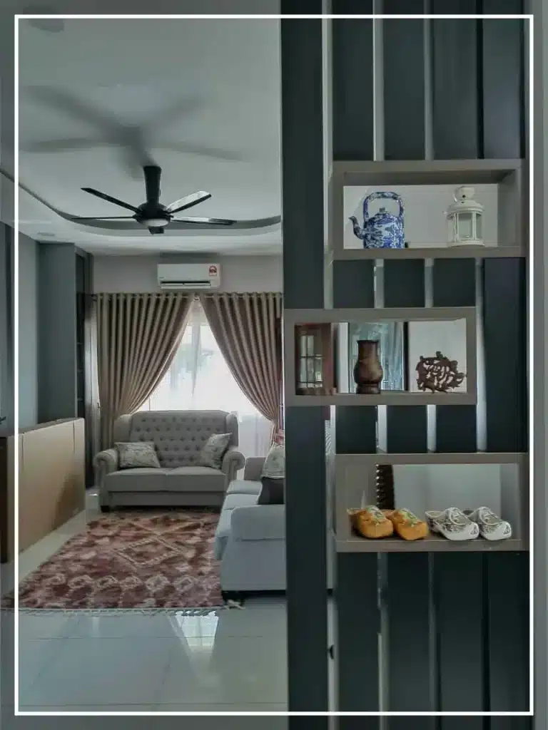 Cara Maksimumkan Kelayakan Loan Rumah 2025: 8 Rahsia Yang Bank Tak Akan Beritahu Anda! 6 Cozy living room with beige sofa, decorative shelves, ceiling fan, and elegant curtains.