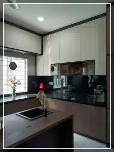 Modern kitchen with wood cabinets, black countertops, and island sink under bright lighting.