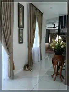 Elegant home interior with brown curtains, decorative table with flowers, and a cozy dog lying on glossy tiled floor.