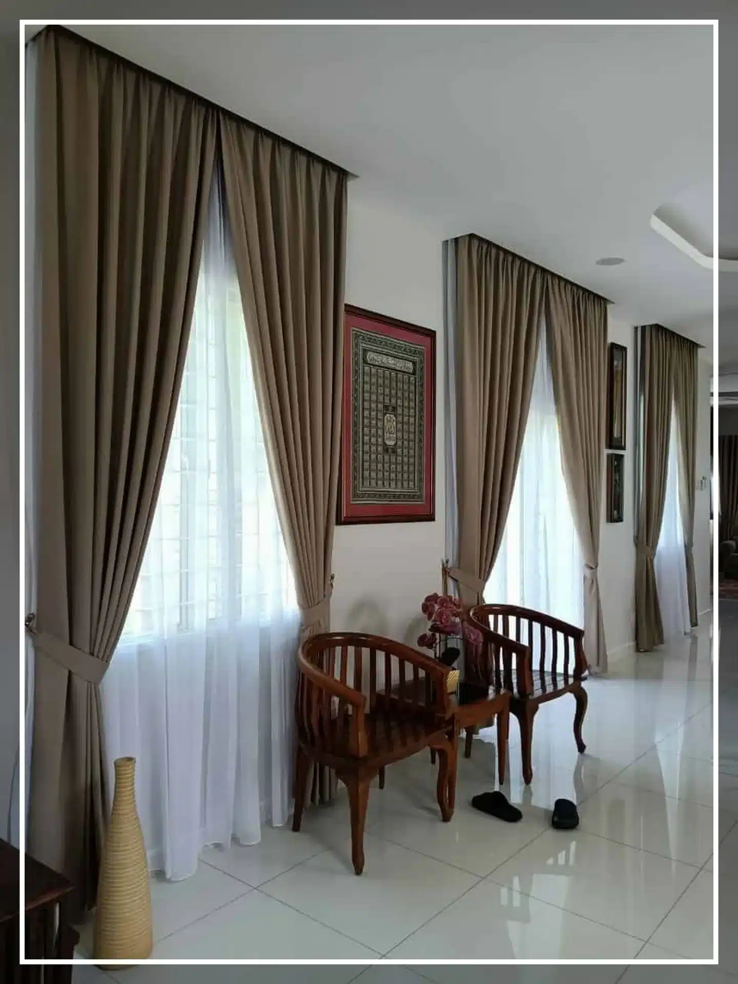 Elegant hallway with brown curtains, wooden chairs, and decorative wall art. Cozy and classy interior design.