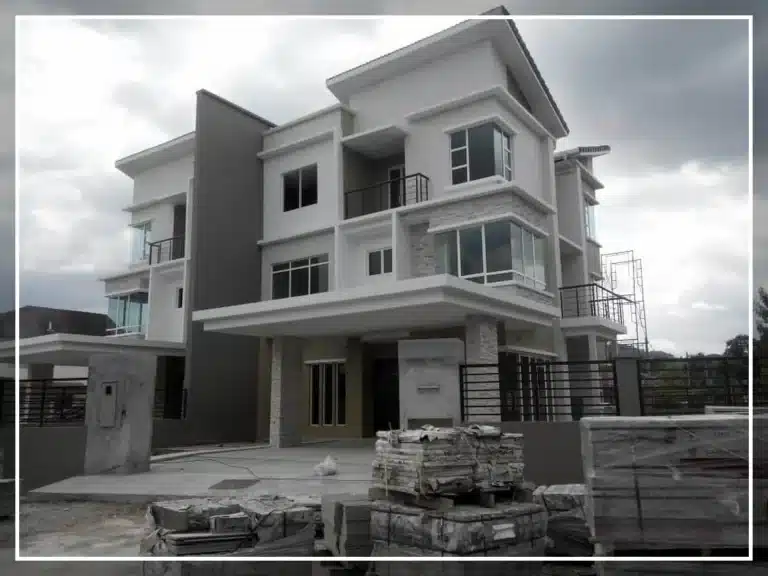 Rahsia Beli Tanah & Bina Rumah Guna LPPSA: 8 Langkah Mudah yang Ramai Tak Tahu! 4 Modern two-story house under construction with glass windows and grey accents, featuring an unfinished driveway.